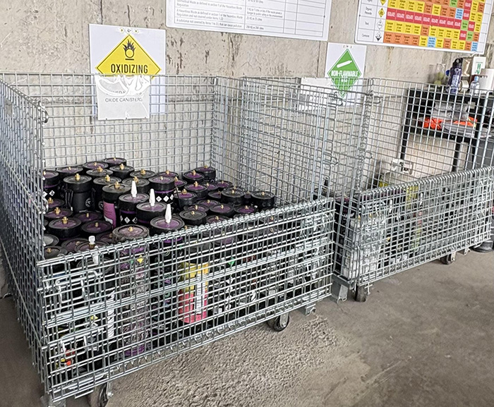 Collection bins for nitrous oxide cylinders at a Metro Vancouver recycling and waste centre